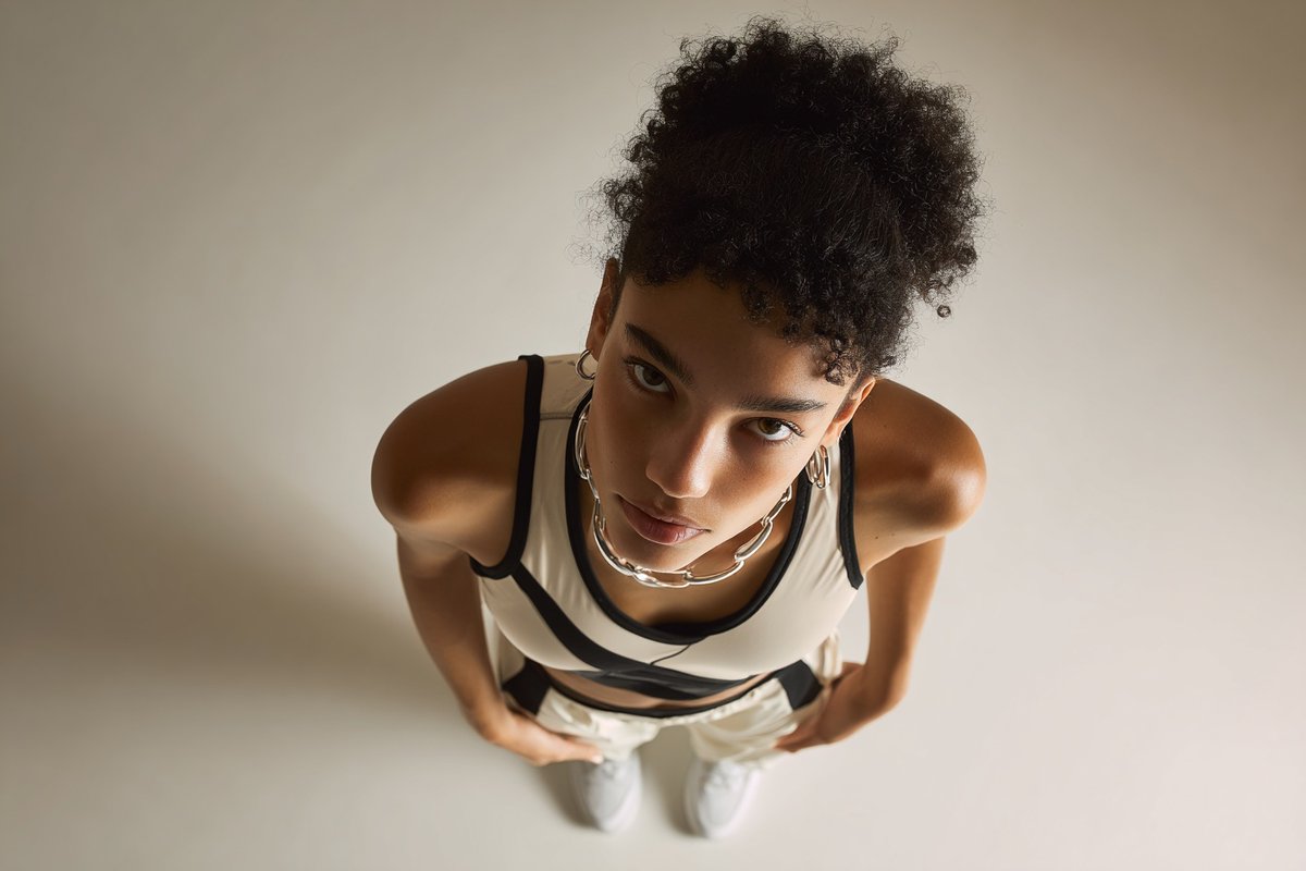 A [subject] photographed from a 35-degree overhead angle, standing alone in an off-white studio  2