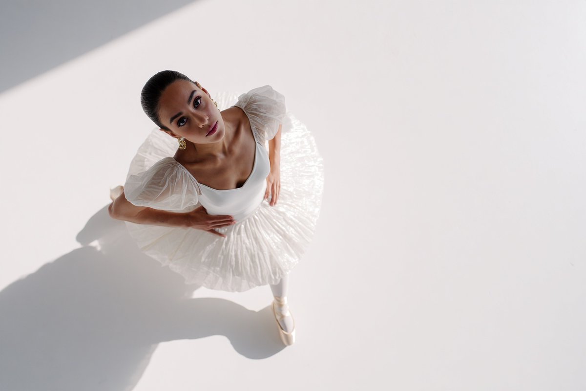 A [subject] photographed from a 35-degree overhead angle, standing alone in an off-white studio  3