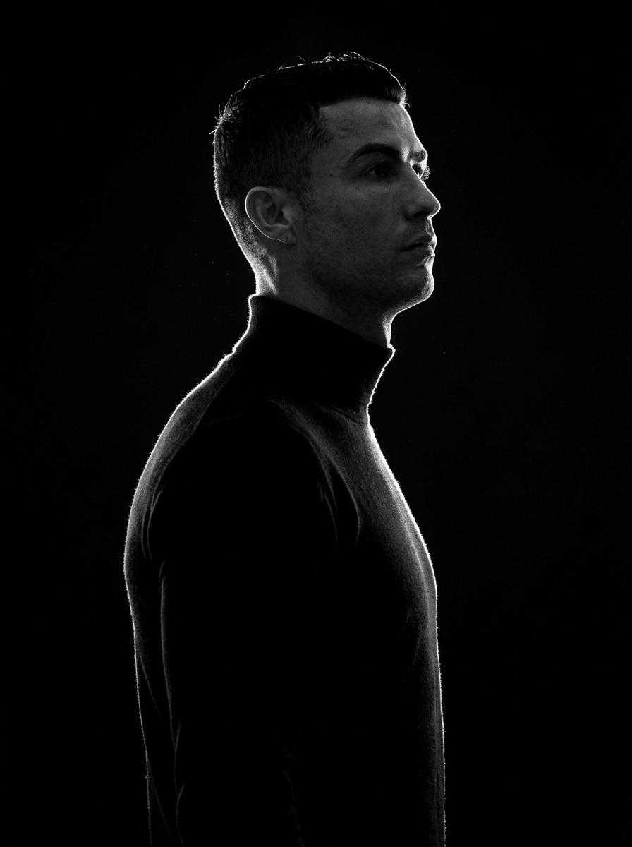 A minimalist black and white cinematic portrait featuring two individuals (male and female) in s