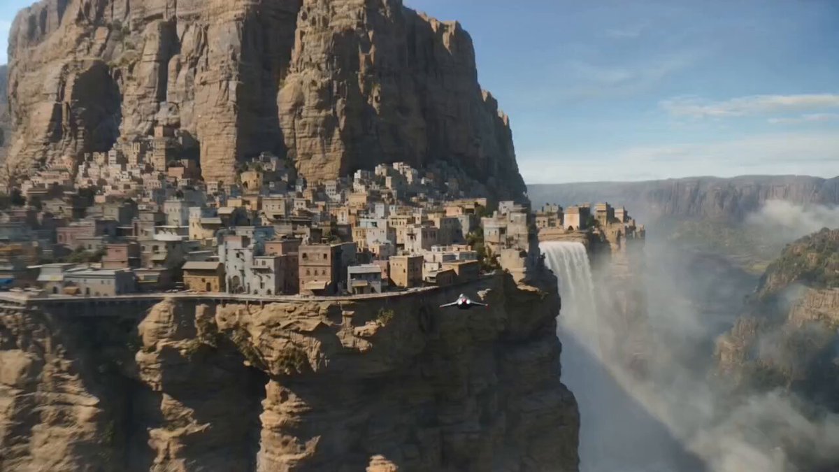 Speeder chase across a cliff city (single continuous shot) From a monumental cliffside city carv