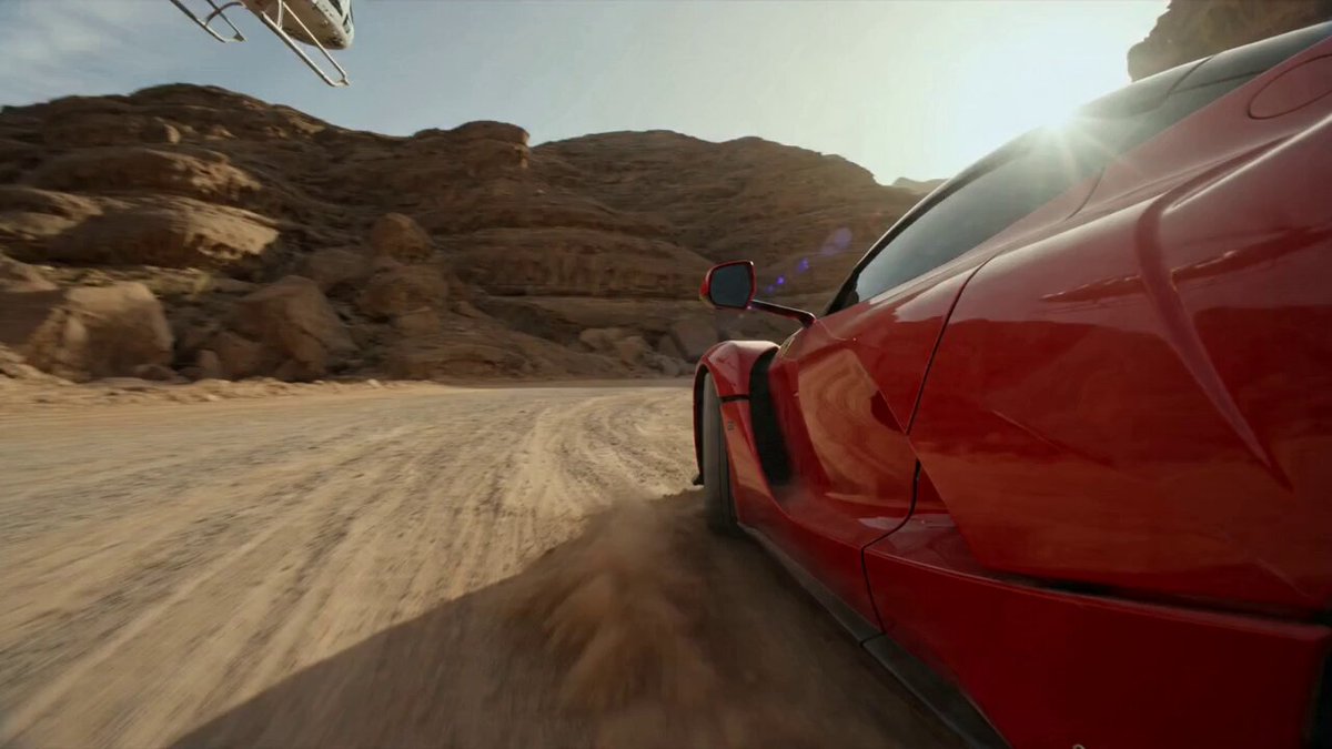 A hyper-realistic, high-octane cinematic video captures a red supercar drifting around a dirt co