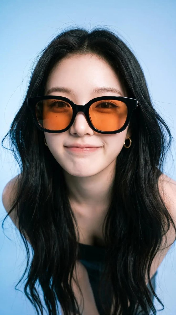 Photorealistic editorial portrait of a smiling woman using the exact same face from the referenc 2