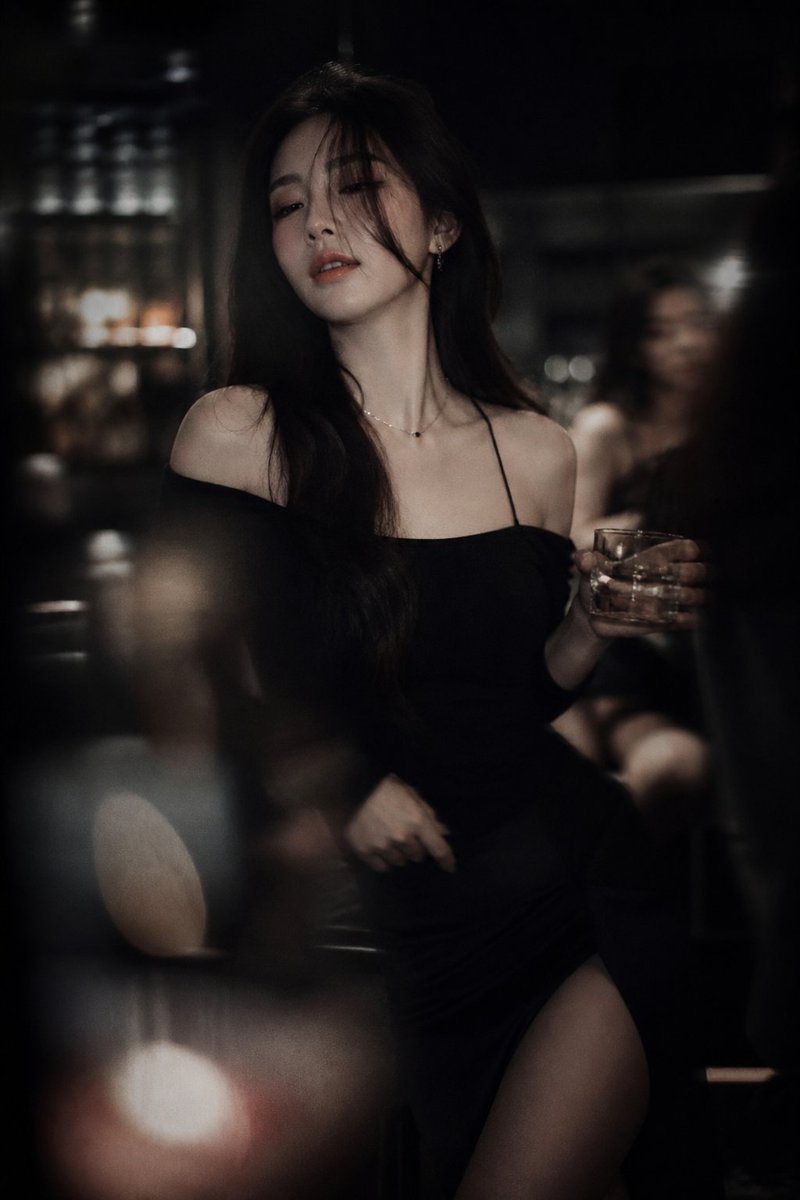 Low-light cinematic portrait, telephoto lens compression, shallow depth of field, intentional so