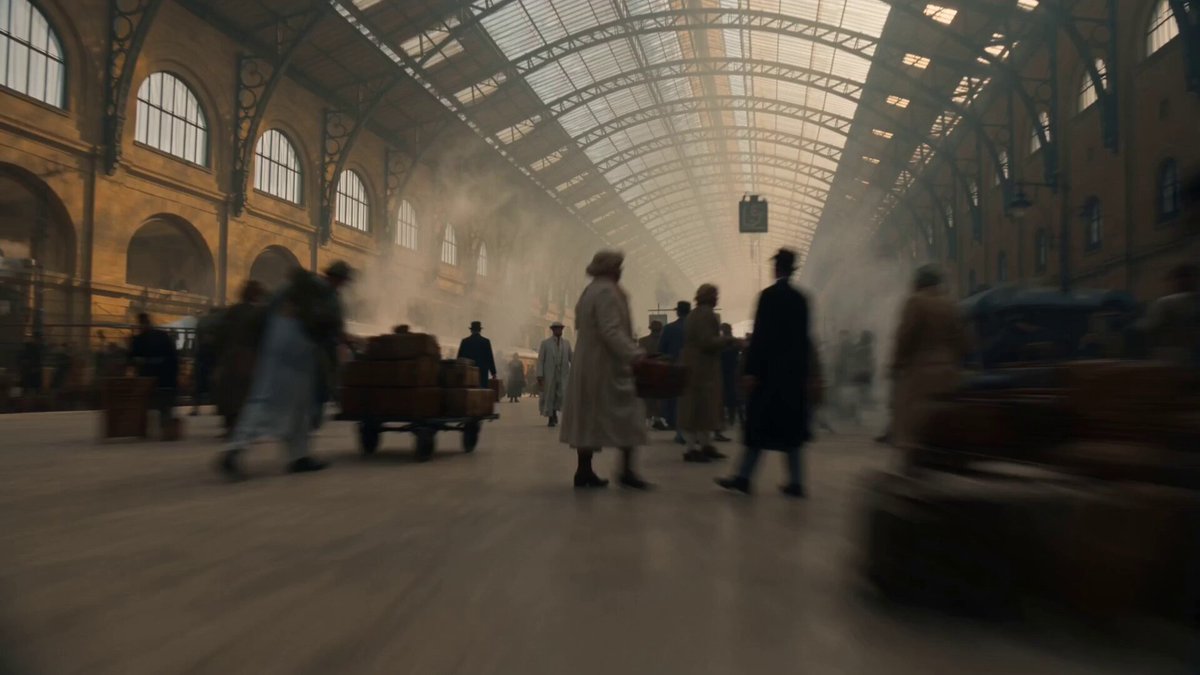 High-energy cinematic one-shot inside a massive Egyptian train station at dawn,