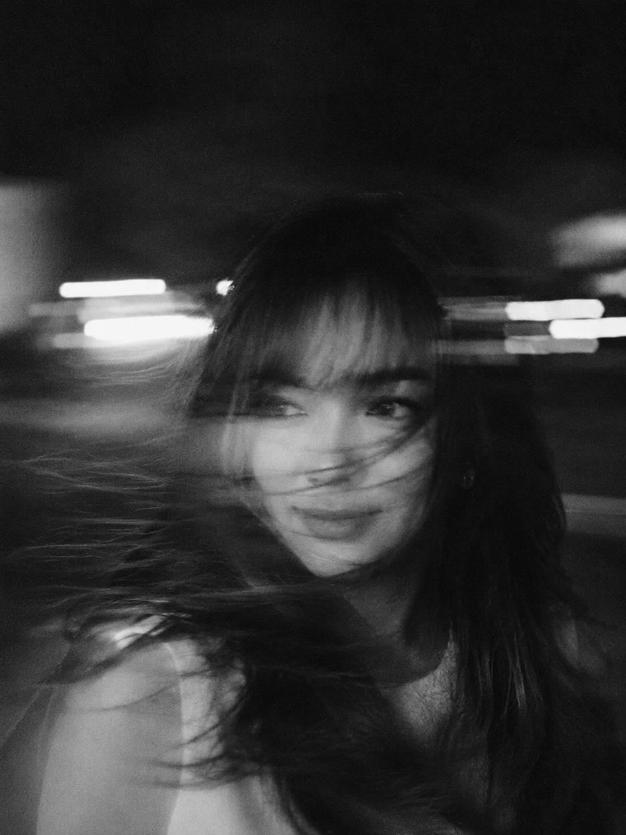 A hyper-realistic, cinematic black-and-white portrait of a woman caught in mid-motion, her face  2