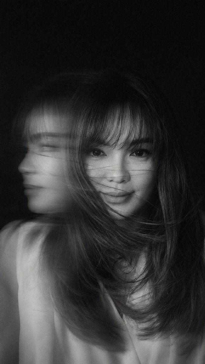 A hyper-realistic, cinematic black-and-white portrait of a woman caught in mid-motion, her face 