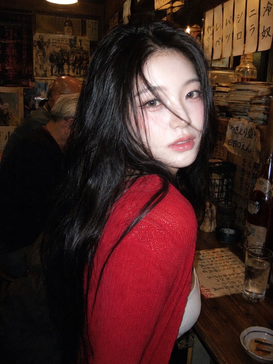 A 90s disposable-camera style flash snapshot taken inside a small, bustling Japanese izakaya dec 2