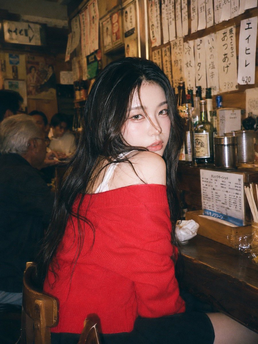 A 90s disposable-camera style flash snapshot taken inside a small, bustling Japanese izakaya dec 3