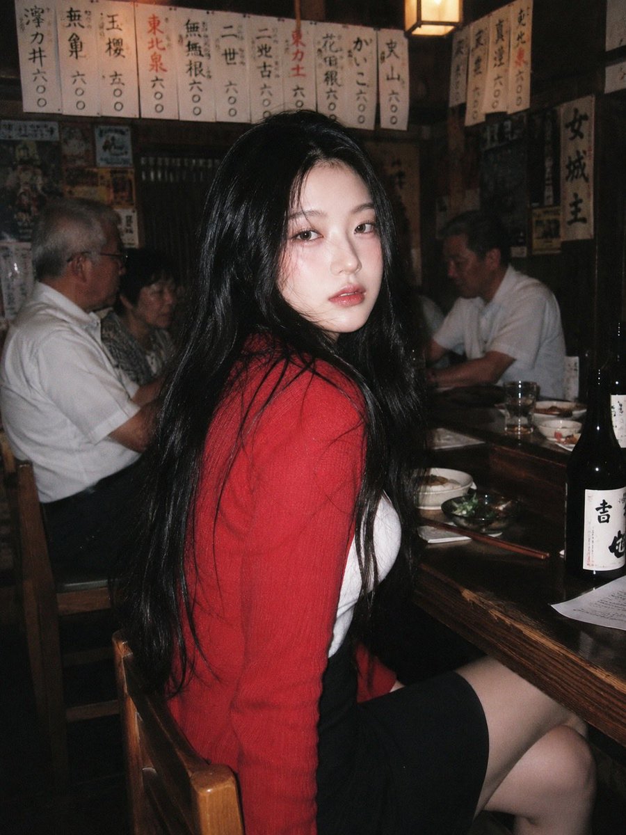 A 90s disposable-camera style flash snapshot taken inside a small, bustling Japanese izakaya dec